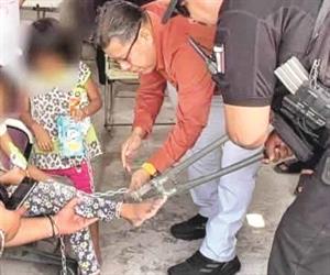 Atan a dos niñas con cadenas y candados
